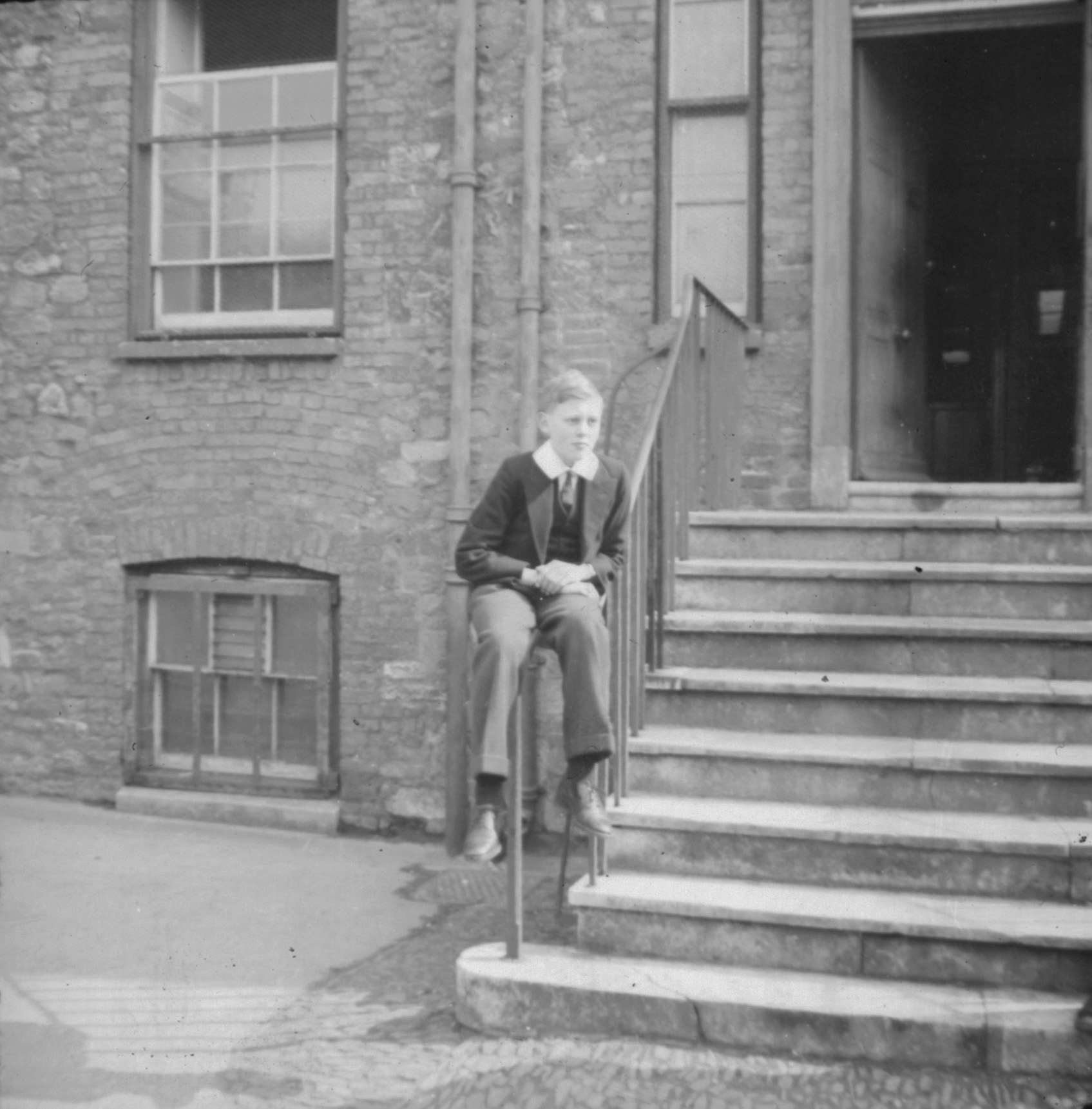 Eric Dare sitting on steps' railings. Mar[ch 19]42